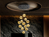 Schuller Zaria 13-light chandelier, black/bronze/amber, D60, dim, 502344