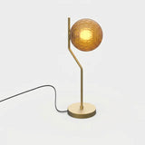 Lámpara de sobremesa ACB Maui oro viejo mate con tulipa Parma ámbar facetada